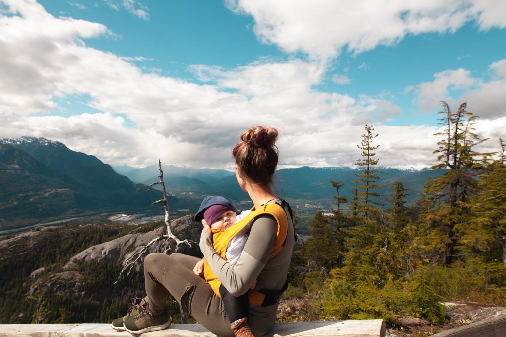 A mother and her baby resting on a mountain overlook